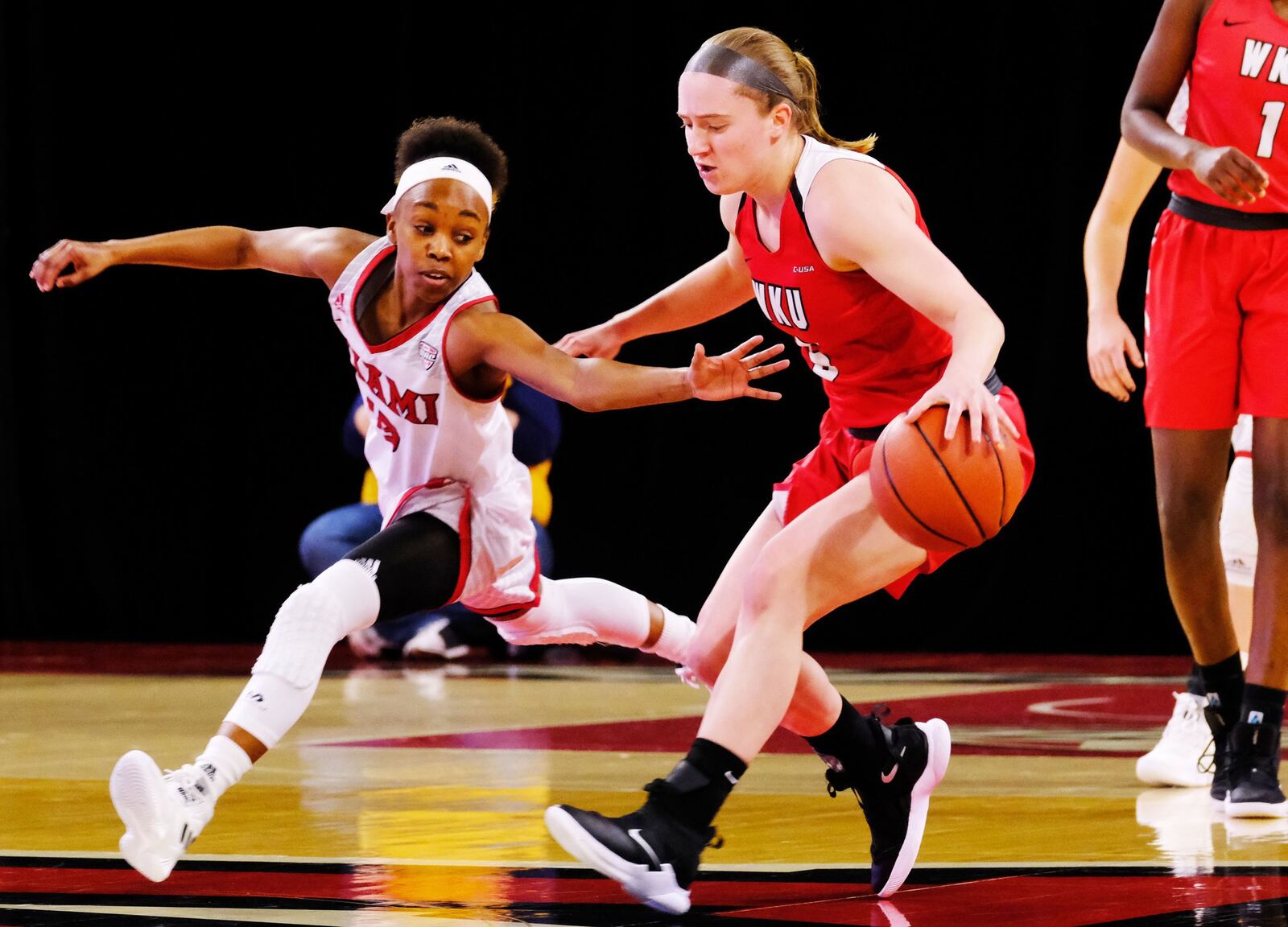 Miami University’s Lauren Dickerson defends Western Kentucky’s Whitney Creech during Thursday night’s WNIT game at Millett Hall in Oxford. WKU won 67-63. SCOTT KISSELL/MIAMI UNIVERSITY