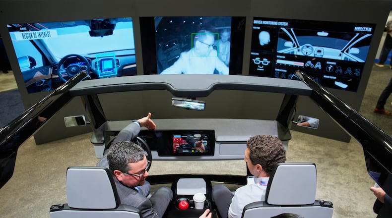 People experience a Gentex Corporation driver and in-camera monitoring system exhibit during the CES tech show Tuesday, Jan. 6, 2026, in Las Vegas. (AP Photo/John Locher)