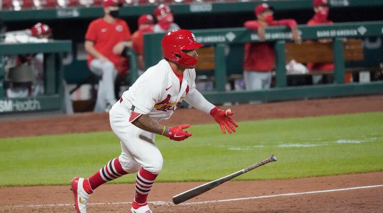 St. Louis Cardinals' Kolten Wong drops his bat after hitting a walk-off single to defeat the Cincinnati Reds in a baseball game Thursday, Aug. 20, 2020, in St. Louis. (AP Photo/Jeff Roberson)