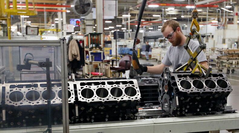 Worker Mat Gray moves Duramax Diesel engine blocks to the DMAX assembly line in Moraine. TY GREENLEES / STAFF