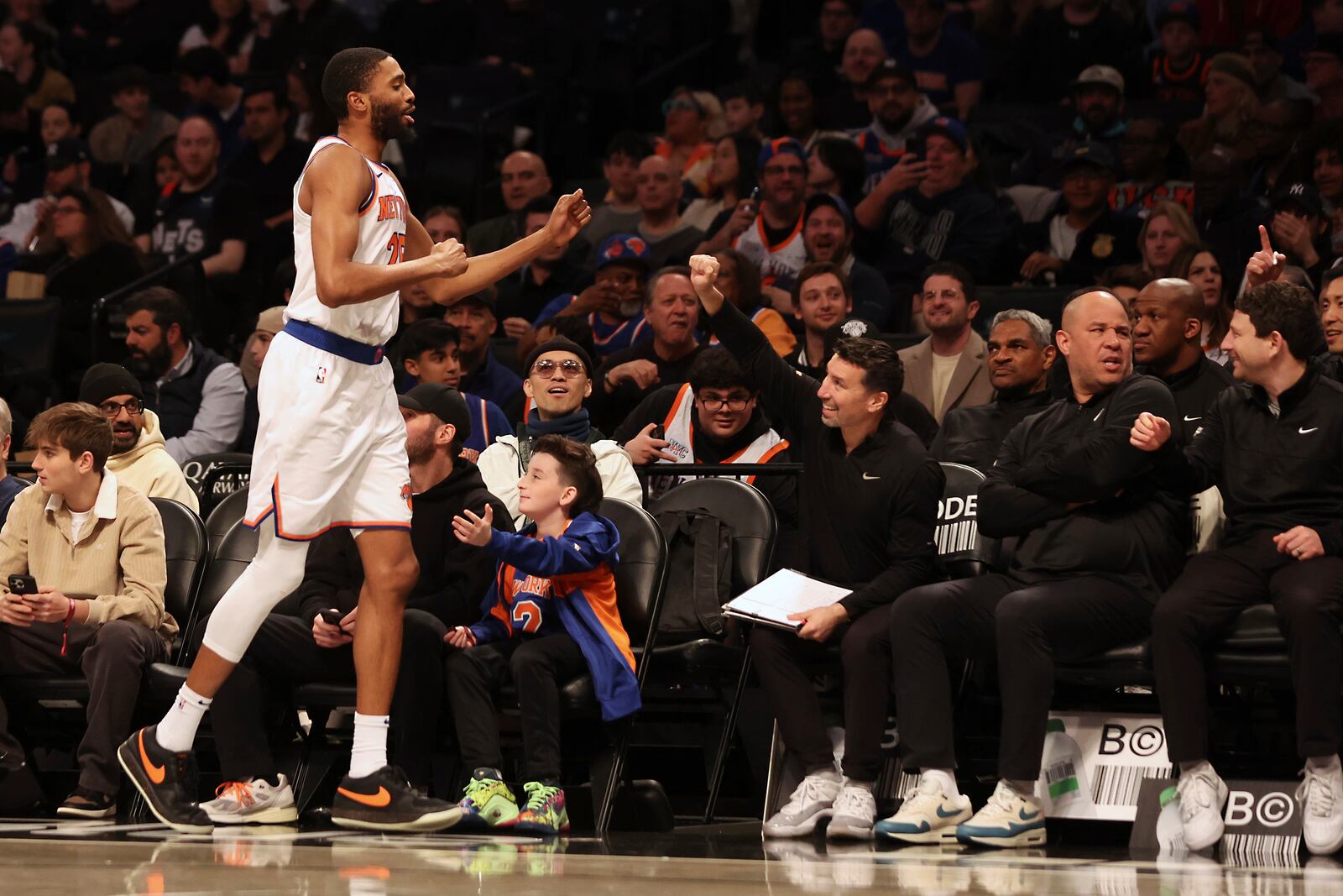 New York Knicks forward Mikal Bridges (25) checks out and returns to the bench during the first half of an NBA basketball game against the Brooklyn Nets, Sunday, April 13, 2025, in New York. (AP Photo/Heather Khalifa)