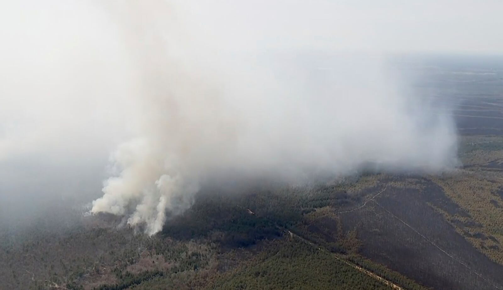 Smoke fills the air from a wildfire in Ocean County, N.J. on Thursday, April 24, 2025. (WPVI-TV via AP)
