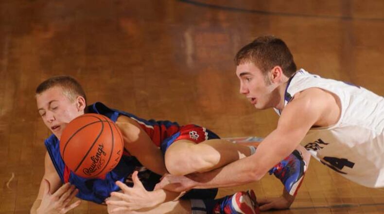 Alec Nix of Greeneview and Ben Dilworth of Fort Recovery battle at mid court for possesion.