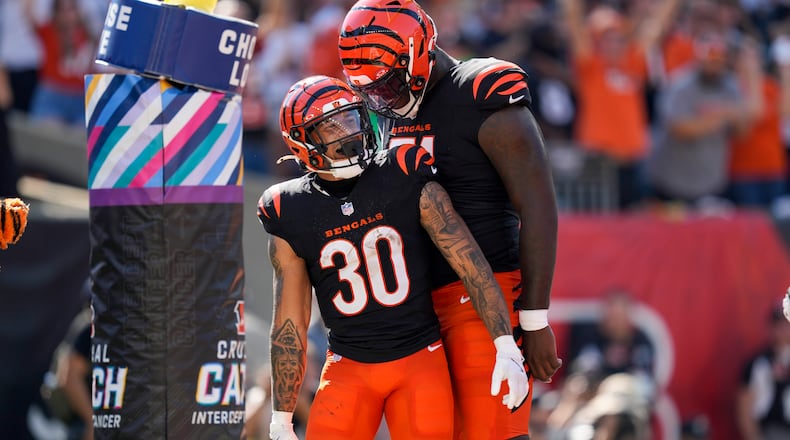Cincinnati Bengals running back Chase Brown (30) reacts with offensive tackle Amarius Mims after catching a 2-point conversion pass against the Baltimore Ravens during the first half of an NFL football game, Sunday, Oct. 6, 2024, in Cincinnati. (AP Photo/Carolyn Kaster)