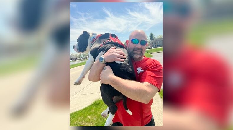 Mike carried Barney when the pooch got to hot to walk. SHANNON ROACH/CONTRIBUTED