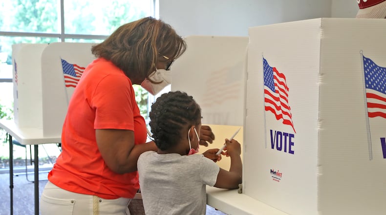 A woman gets some help filling out her ballot Tuesday, August 2, 2022 at the election poll in the Springfield Township Government Center. BILL LACKEY/STAFF