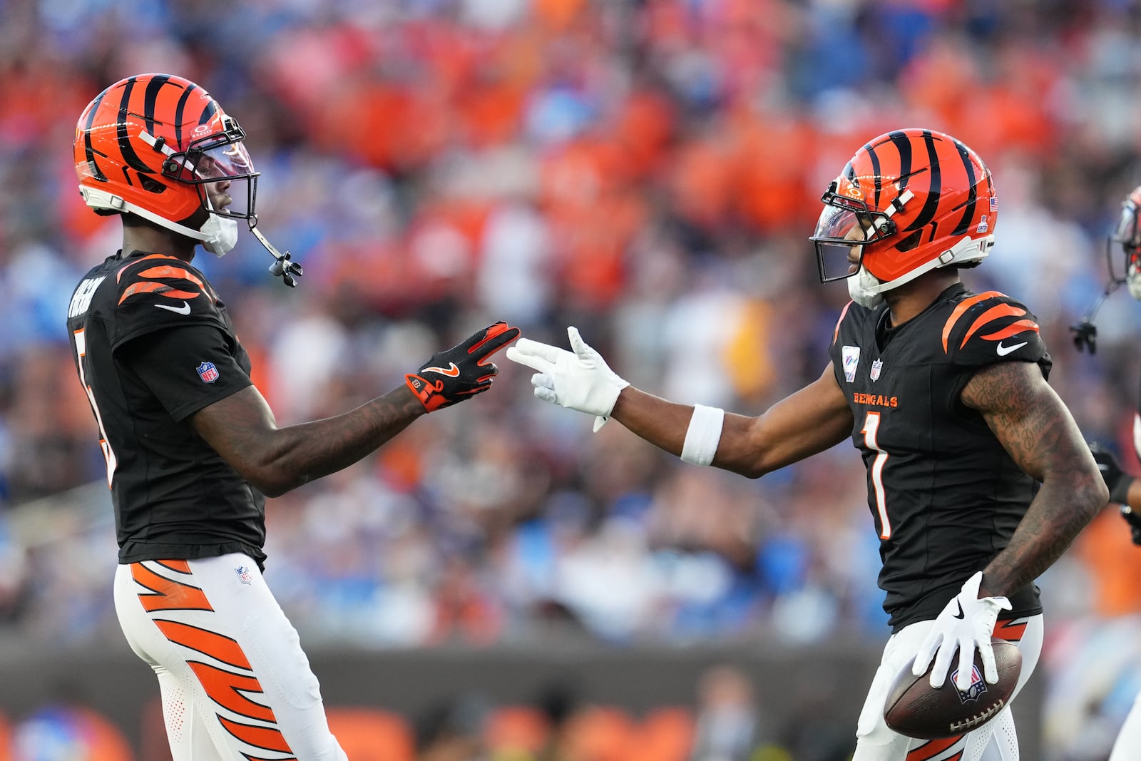 Cincinnati Bengals wide receiver Ja'Marr Chase, right, celebrates his 64-yard touchdown reception with Tee Higgins, left, against the Detroit Lions during the second half of an NFL football game Sunday, Oct. 5, 2025, in Cincinnati. (AP Photo/Jeff Dean)