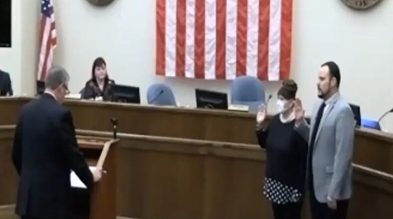 Monroe Law Director Philip Callahan prepares to swear in Keith Funk and Christina McElfresh as mayor and vice mayor, respectively, before Tuesday's meeting. RICK McCRABB/STAFF