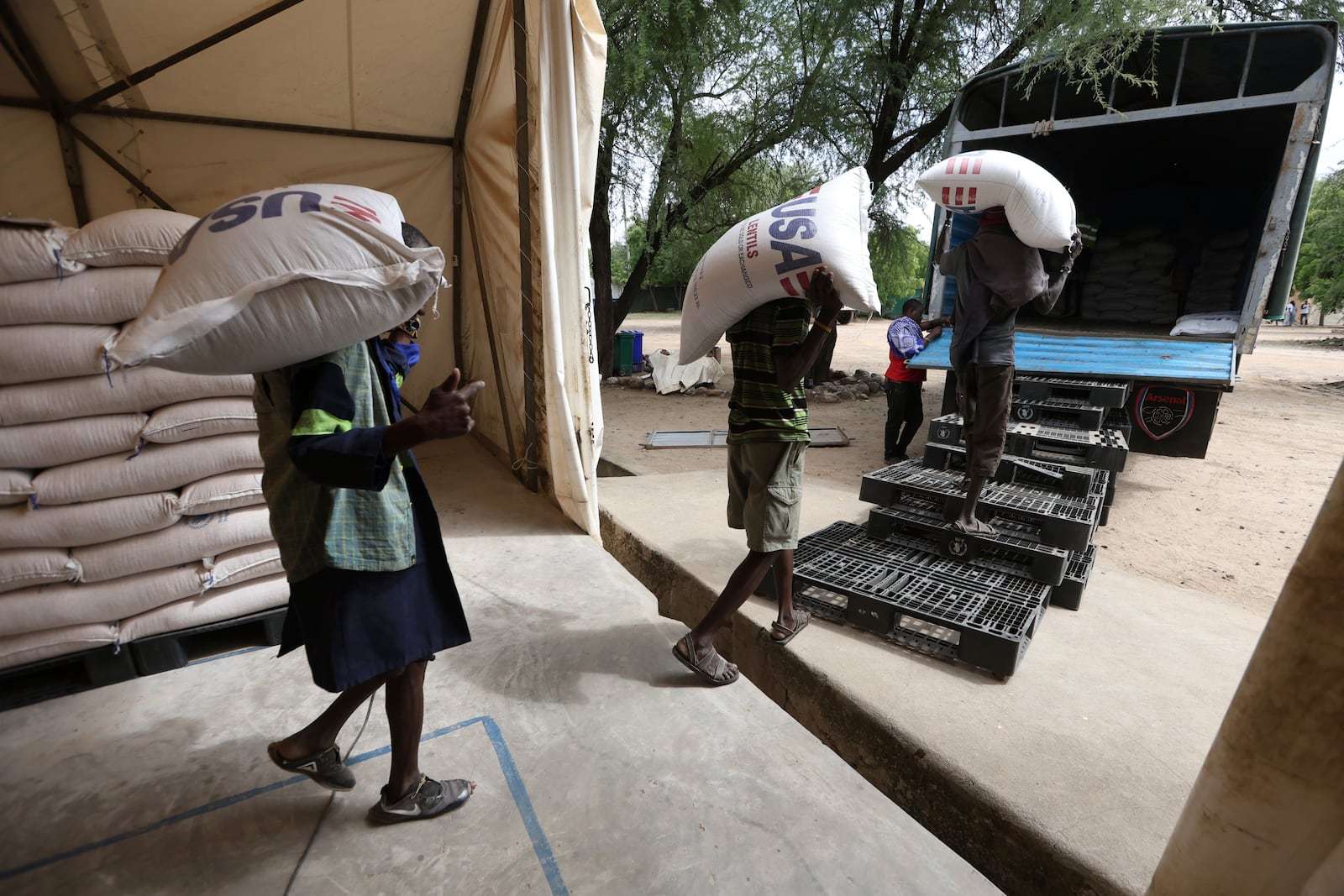 Workers load USAID humanitarian aid into a truck at a World Food Programme (WFP) warehouse in Kakuma Refugee Camp, Turkana, Kenya Tuesday, June 3, 2025. (AP Photo/Andrew Kasuku)