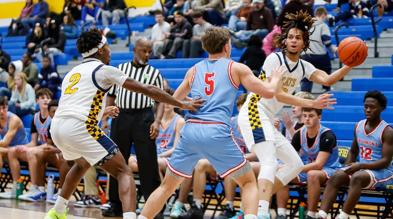 Springfield High School junior Immanuel Carey saves the ball from going out of bounds during their game against Fairmont on Tuesday, Jan. 6 at Springfield High School. The Firebirds won 54-46. MICHAEL COOPER / STAFF PHOTO