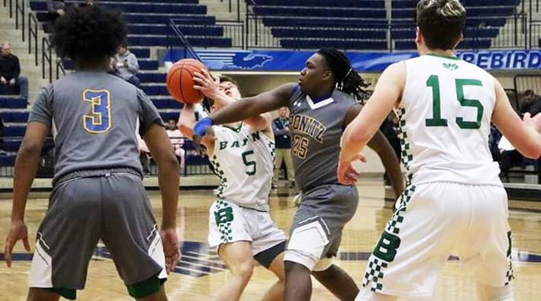 Badin’s Donovan Watkins (5) is closely defended by Anthony Wilson (25) of Ponitz during Friday night’s Division II sectional basketball game at Fairmont’s Trent Arena in Kettering. Badin won 54-33. CONTRIBUTED PHOTO BY TERRI ADAMS