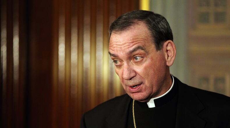 Archbishop of Cincinnati Dennis M. Schnurr answers questions from the media at the archdiocese cathedral offices in downtown Cincinnati in this 2013 file photo. STAFF