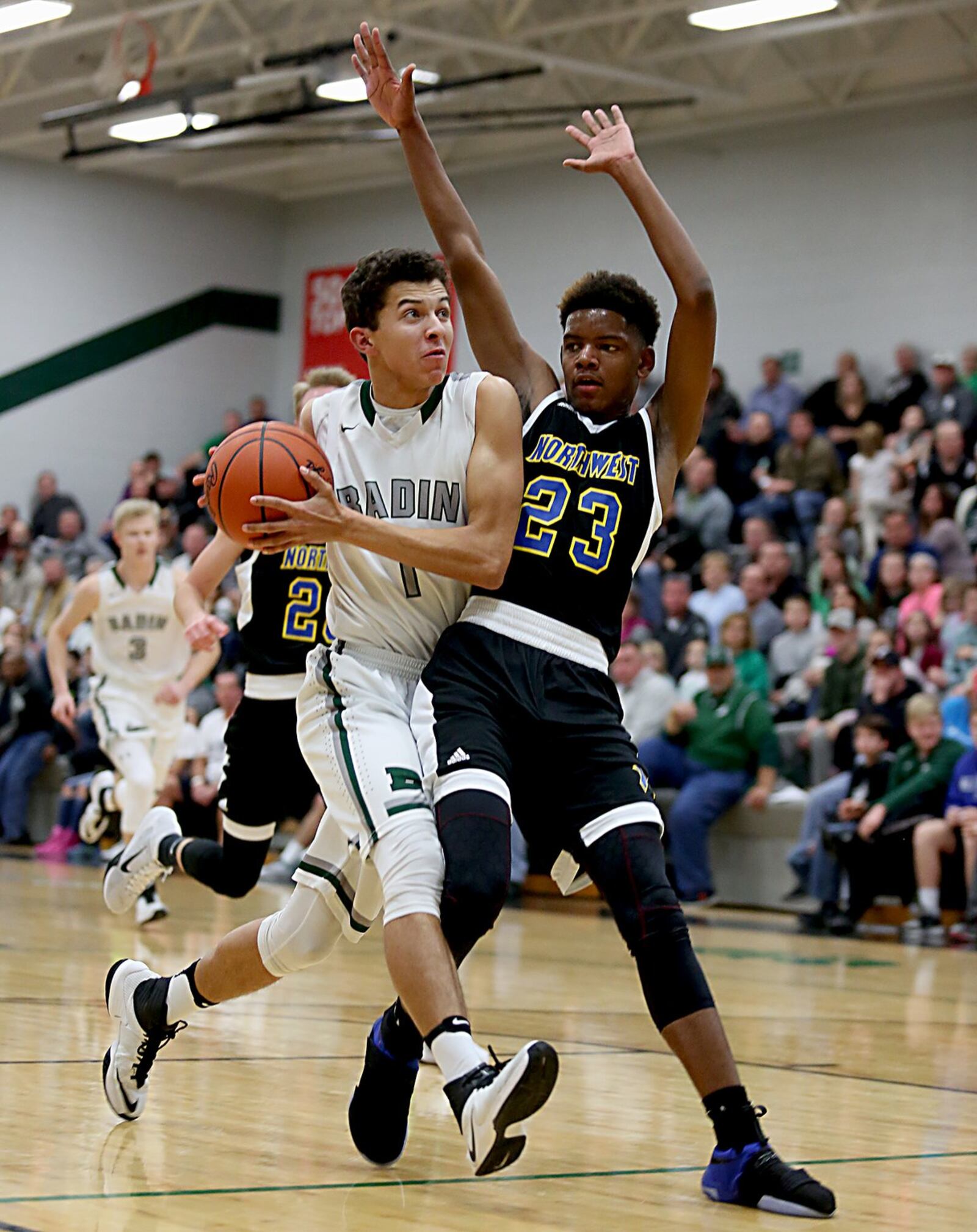 Badin wing Caleb Meyer is covered by Northwest guard Tyree McKinney during their game at Mulcahey Gym in Hamilton on Wednesday night. CONTRIBUTED PHOTO BY E.L. HUBBARD