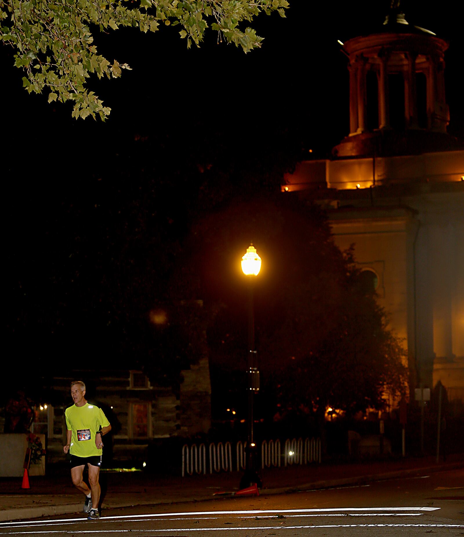 A runner competes in the Midnight Madness Marathon last year in Hamilton. This year’s NightGlow Marathon will take place Sept. 2.