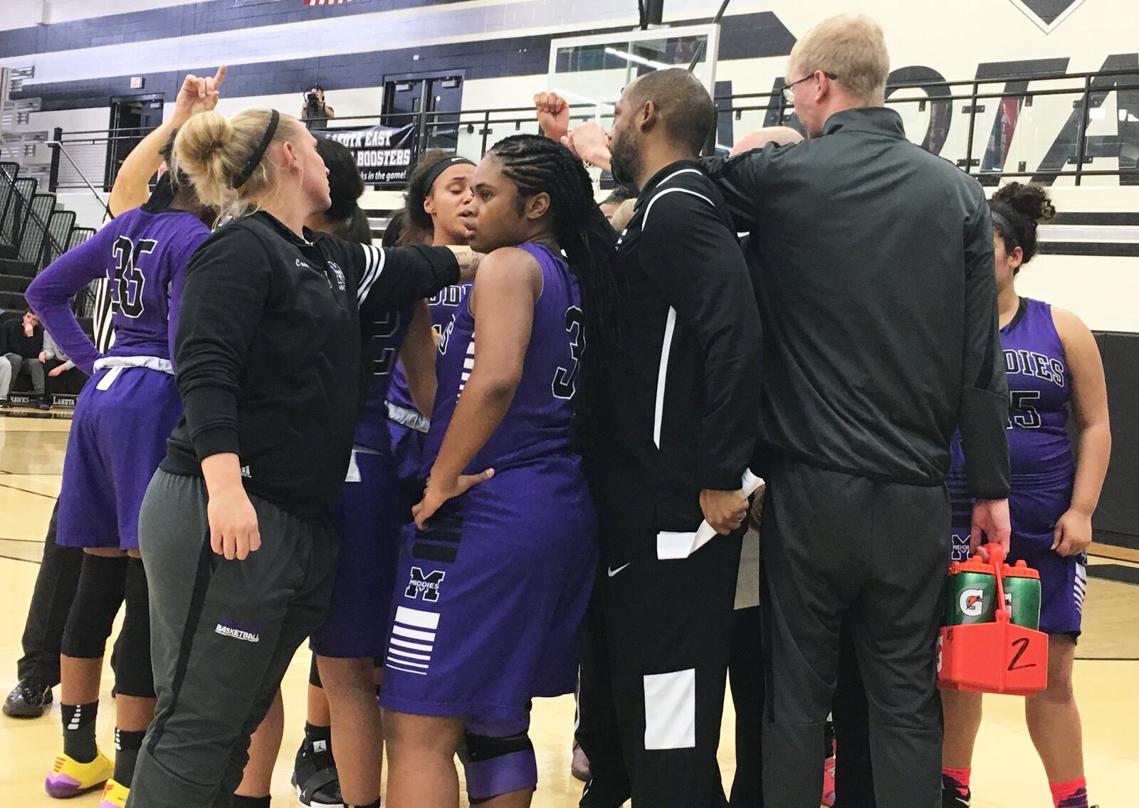 Middletown coach Kevin Aldridge (holding paper) huddles with his team during a timeout Wednesday night at Lakota East. The host Thunderhawks won 48-43. RICK CASSANO/STAFF