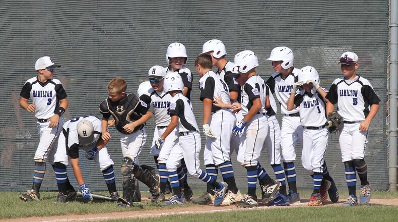 West Side celebrates after a three-run home run by Cam Carter during a victory over Mount Vernon in the second round of the Little League state tournament on Tuesday, July 23, 2019, at Bevelhymer Park in New Albany.