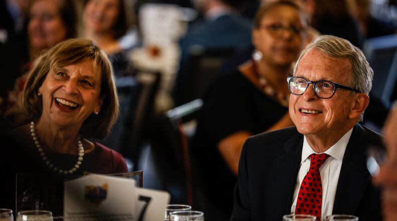 Fran and Gov. Mike DeWine react to comments by the MC of the 2021 Dayton Walk of Fame celebration was held Tuesday morning Oct. 12, 2021 at Sinclair Community College. The Walk of Fame recognizes the lives of accomplishments of individuals from the Greater Miami Valley area. Some notables from Tuesday event are, Gov. Mike DeWine and Springfield entertainer, John Legend. JIM NOELKER/STAFF
