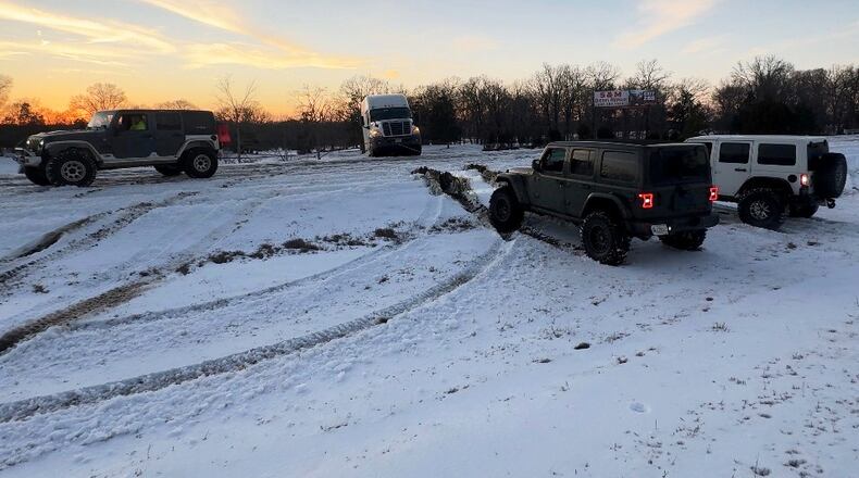 This photo provided by Crystal Walk shows Jeeps helping stranded drivers navigate the ice on Wednesday, Jan. 28, 2026, on Interstate 55 in northern Mississippi. (Crystal Walk via AP)