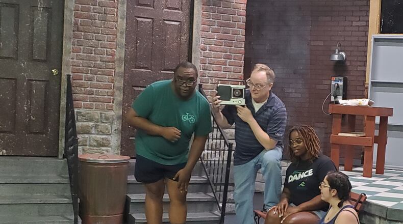 Mushnik (John Dorney) and the Urchins (Cedric Reeder-McClure, Alicia Lacey and Shana Fishbein) listen in on Seymour's radio interview about the rising popularity of Audrey II. CONTRIBUTED