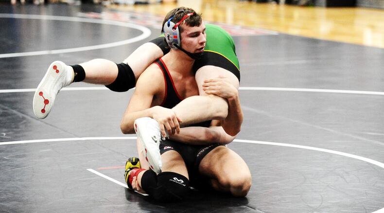 Madison’s Devin Oligee grabs an opponent during a recent match. He’s headed for the Division III state tournament in Columbus at 170 pounds. CONTRIBUTED PHOTO BY GREG BILLING