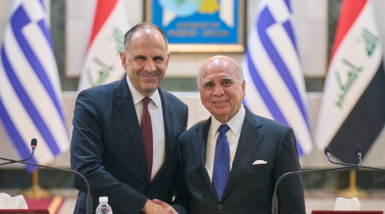 Iraqi Foreign Minister Fuad Hussein, right, shakes hands with his Greek counterpart George Gerapetritis, in Baghdad, Iraq, Thursday, Oct. 30, 2025. (AP Photo/Hadi Mizban)