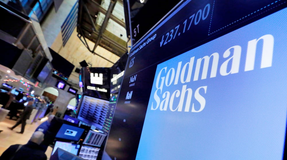 FILE - In this Dec. 13, 2016, file photo, the logo for Goldman Sachs appears above a trading post on the floor of the New York Stock Exchange. (AP Photo/Richard Drew, File)