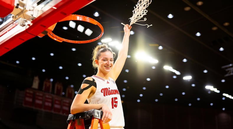 Amber Tretter – the leading scorer and rebounder on Miami’s record setting women’s basketball team – taking part in the net cutting celebration after leading the RedHawks to a rout of Kent State last Wednesday night. The victory – which raised Miami’s record to a program-best 25 victories against just five defeats – brought the RedHawks their first Mid-American Conference regular season title in 22 years. Miami closes out its regular season Saturday evening at Ohio University. MIAMI ATHLETICS / CONTRIBUTED PHOTO