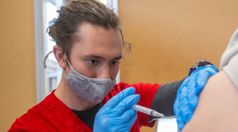 As part of a state-wide push to quickly inoculate college students against the coronavirus, Miami University has deployed its nursing students - including Mike Croy who is pictured - to help in giving the potentially life-saving injections. State officials hope to lessen the spread of the coronavirus by injecting college students and staffers prior to their departure for summer break. (Provided Photo\Journal-News)