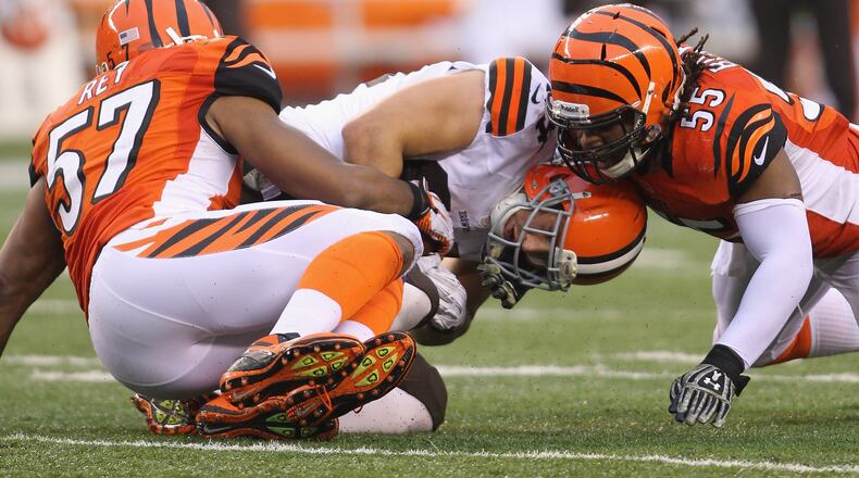 CINCINNATI, OH - NOVEMBER 17:  Vontaze Burfict #55 and Vincent Rey #57 of the Cincinnati Bengals tackle Jordan Cameron #84 of the Cleveland Browns during their game at Paul Brown Stadium on November 17, 2013 in Cincinnati, Ohio.  The Bengals defeated the Browns 41-20.  (Photo by John Grieshop/Getty Images)