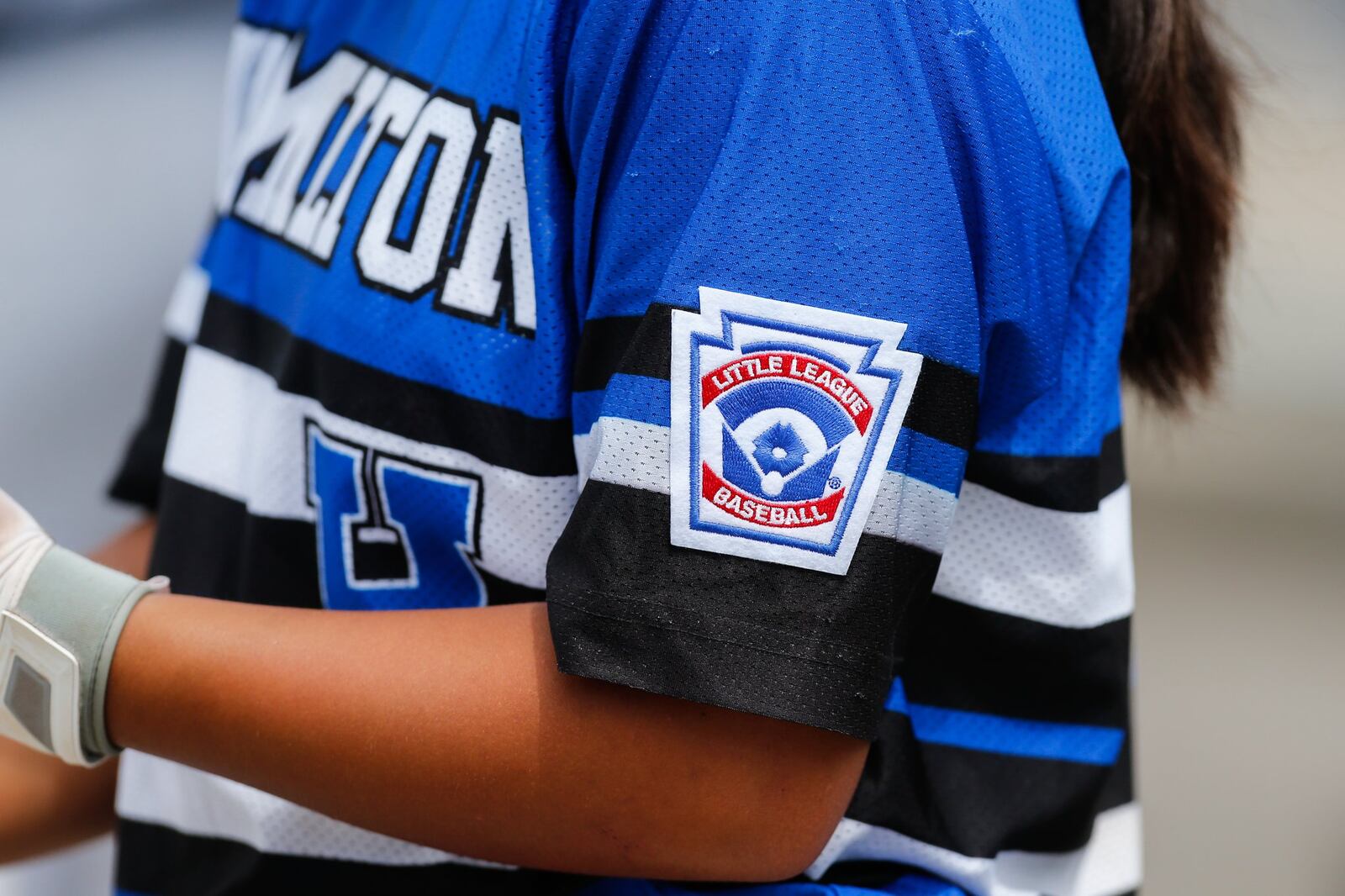 Hamilton West Side’s Katelyn Polido displays her Little League Baseball patch during the state tournament in Maumee. CONTRIBUTED PHOTO BY SCOTT GRAU