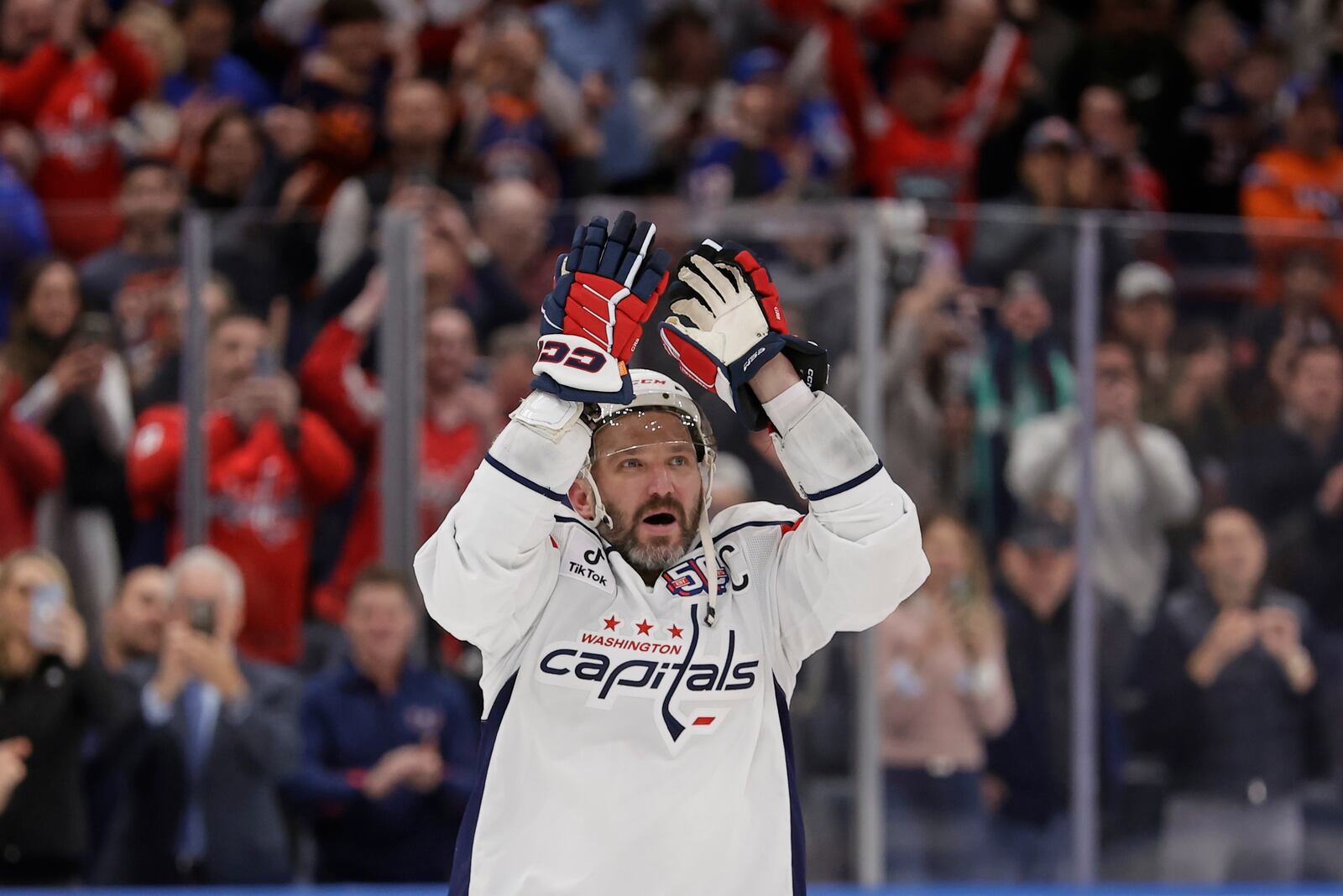 Washington Capitals left wing Alex Ovechkin (8) celebrates after scoring his 895th career goal during the second period of an NHL hockey game against New York Islanders in Elmont, N.Y., Sunday, April 6, 2025. (AP Photo/Adam Hunger)