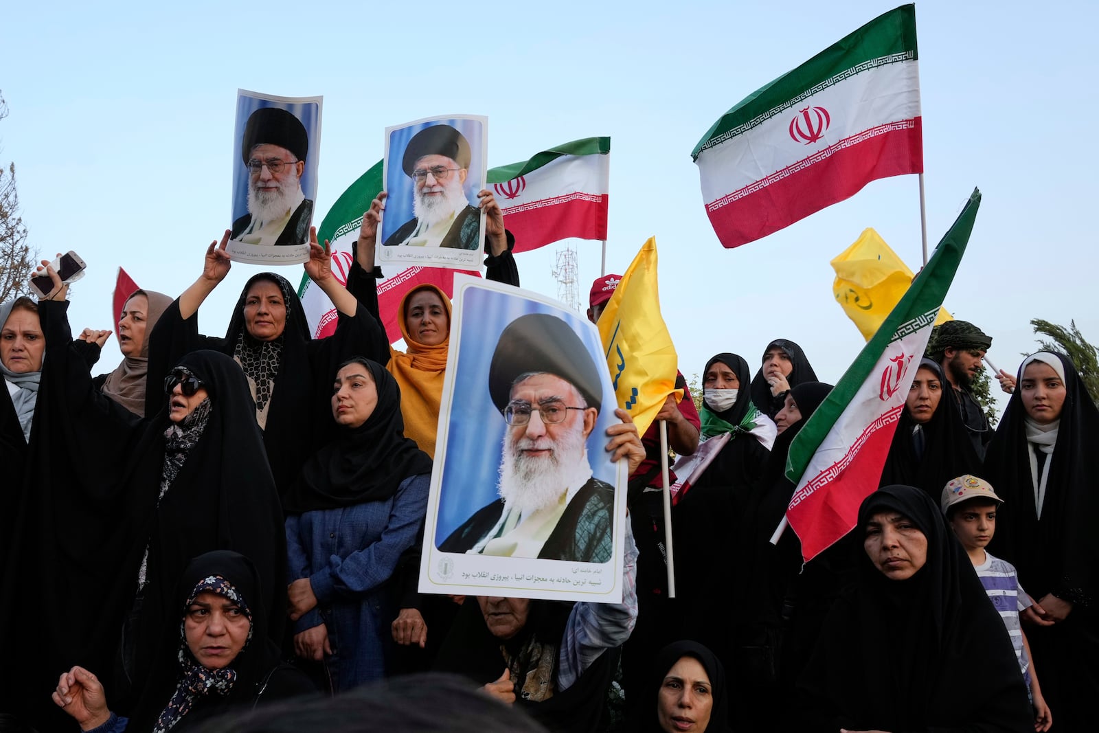 Iranian protesters hold their country's flags and posters of Supreme Leader Ayatollah Ali Khamenei in an anti-U.S. and anti-Israeli rally at Enqelab-e-Eslami (Islamic Revolution) square in downtown Tehran, Iran, Tuesday, June 24, 2025. (AP Photo/Vahid Salemi)