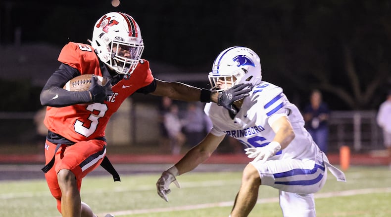 Wayne sophomore quarterback Kye Graham runs with pressure from Springboro's Cole Henson during a Greater Western Ohio Conference game on Friday, Sept. 12 at Heidkamp Stadium. BRYANT BILLING / STAFF