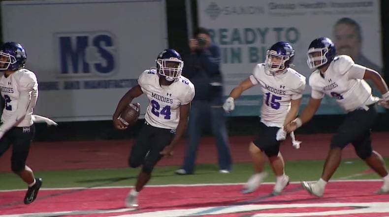 Middletown junior running back Demetrian James celebrates with his teammates after scoring a fourth quarterback touchdown Friday night at Oak Hills. PHILIP LEE/WCPO