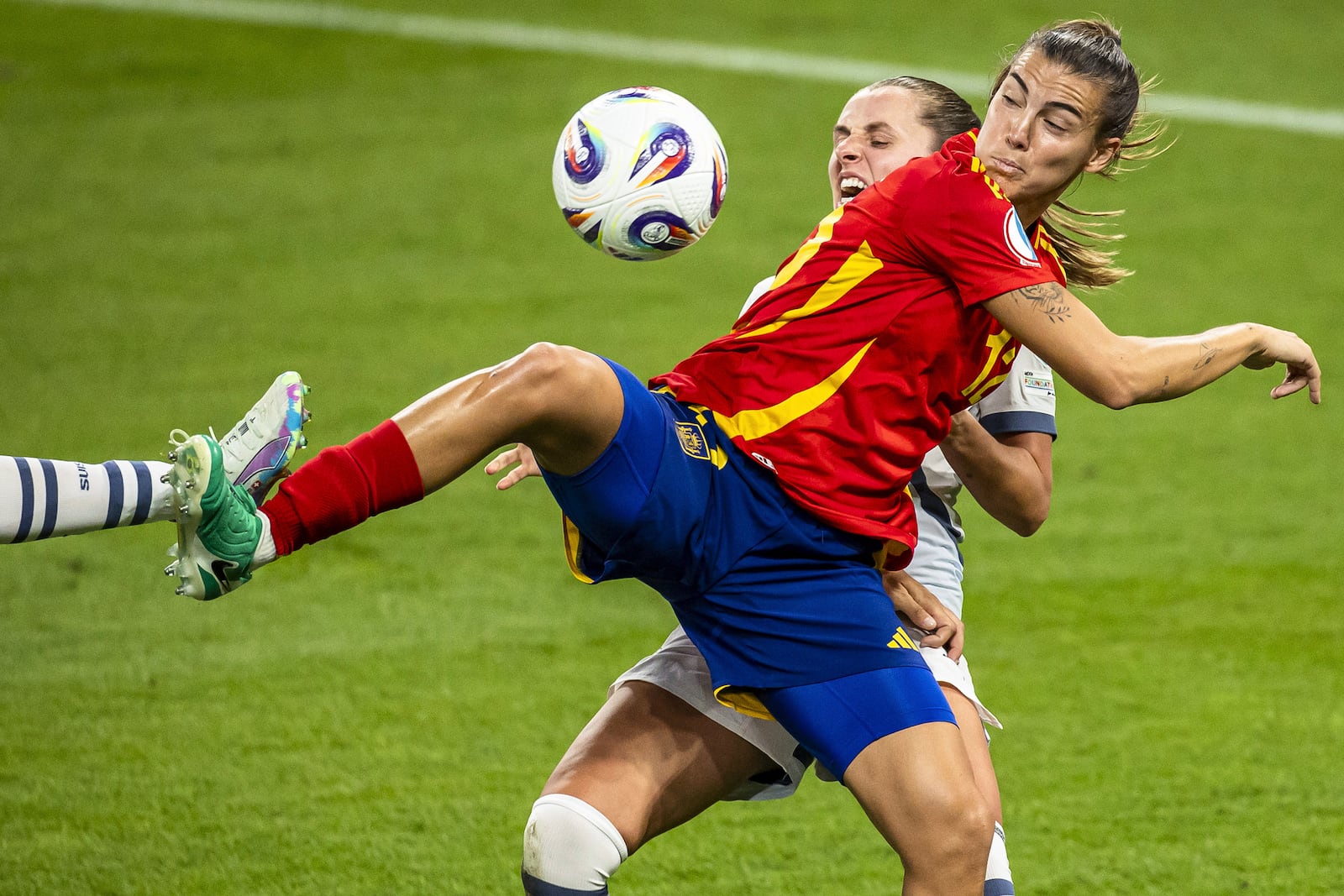 Switzerland's Noelle Maritz, rear, and Spain's Patricia Guijarro in action during the Women's Euro 2025 quarterfinal soccer match between Switzerland and Spain at Wankdorf stadium in Bern, Switzerland, Friday July 18, 2025. (Michael Buholzer/Keystone via AP)