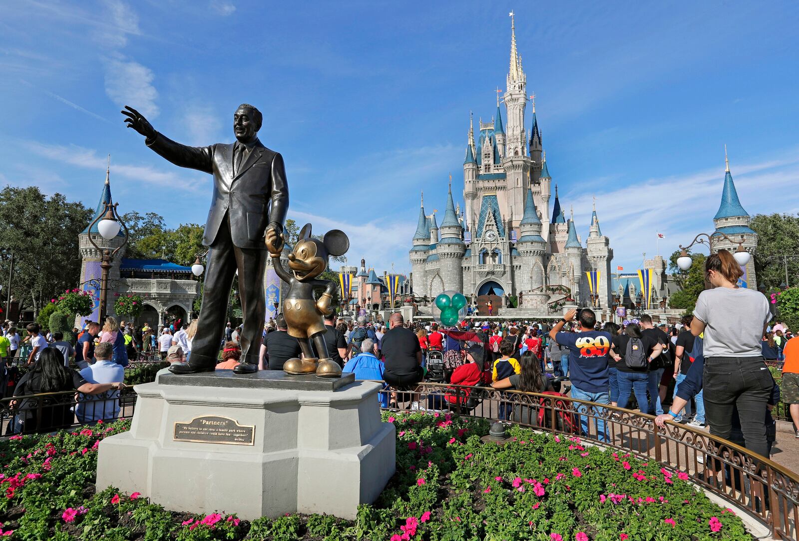FILE - A statue of Walt Disney and Micky Mouse stands in front of the Cinderella Castle at the Magic Kingdom at Walt Disney World in Lake Buena Vista, Fla., Jan. 9, 2019. (AP Photo/John Raoux, File)