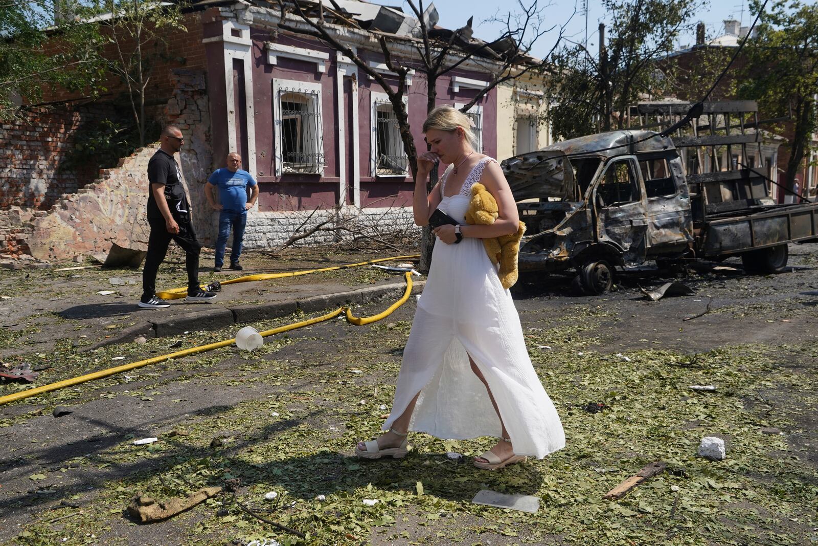 A woman reacts as she leaves her home that was destroyed by a Russian airstrike in Kharkiv, Ukraine, Monday, July 7, 2025. (AP Photo/Andrii Marienko)