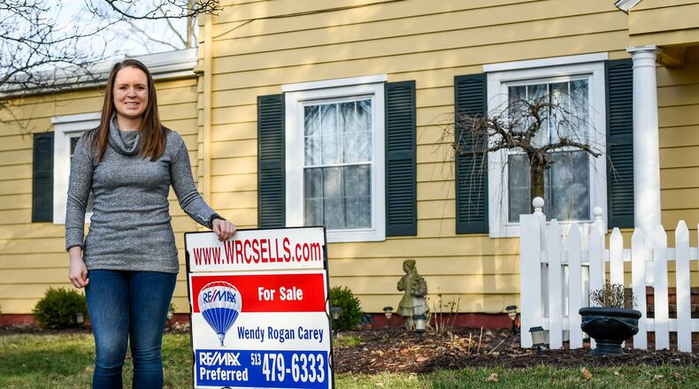 Mollee Schierloh stands in front of the home she recently bought in Middletown. The local home sales market almost matched 2005 numbers, a sign the economy continues to rebound following the recession. NICK GRAHAM/STAFF