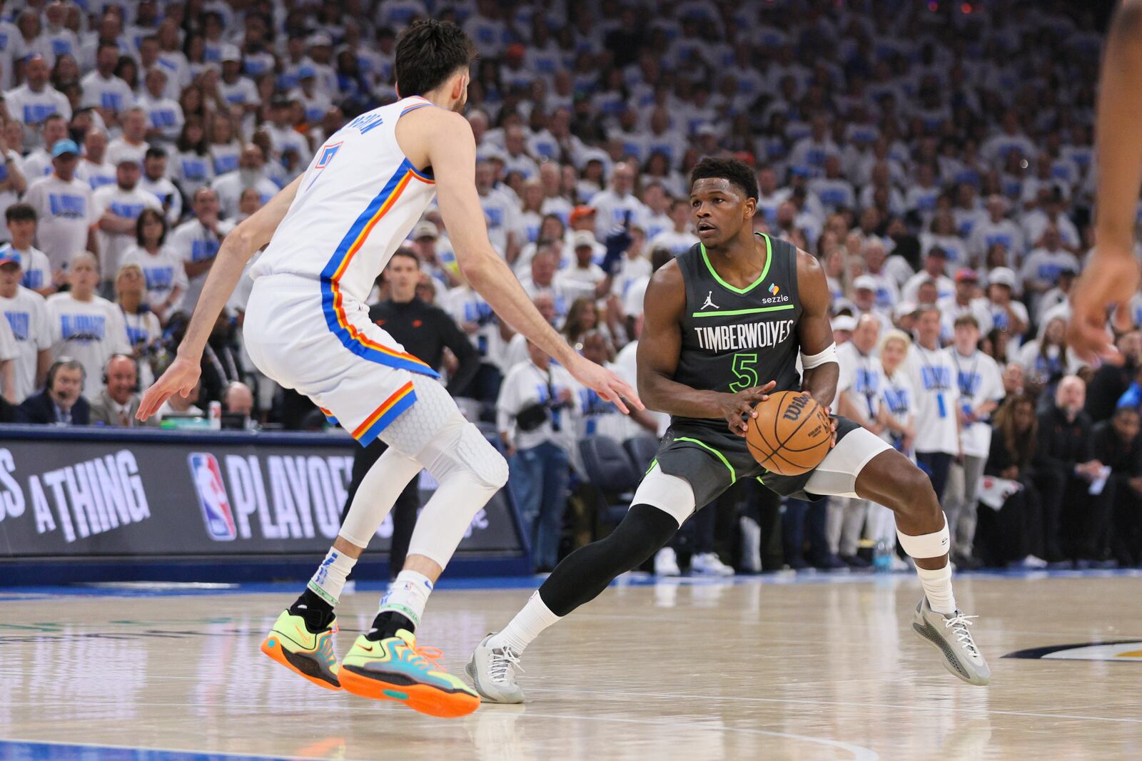 Minnesota Timberwolves guard Anthony Edwards (5) works the floor against Oklahoma City Thunder forward Chet Holmgren during the first half of Game 1 of an NBA basketball Western Conference Finals playoff series Tuesday, May 20, 2025, in Oklahoma City. (AP Photo/Nate Billings)