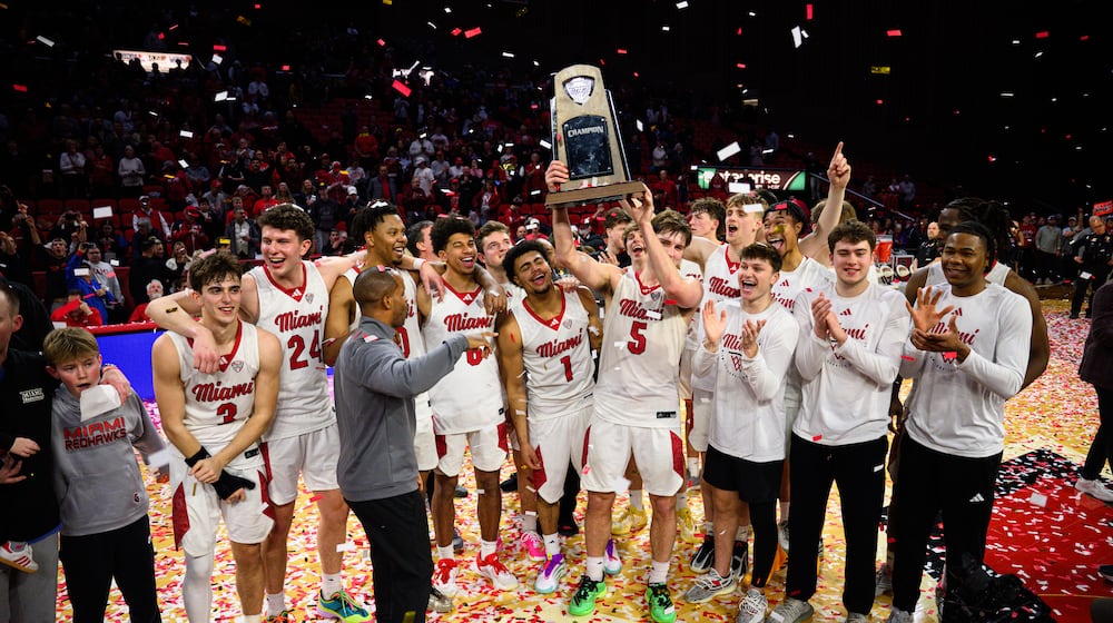 The Miami University men's basketball team hoists the Mid-American Conference trophy after beating Toledo 74-72 on Tuesday, March 3, 2026 at Millett Hall. JEREMY MILLER / CONTRIBUTED PHOTO