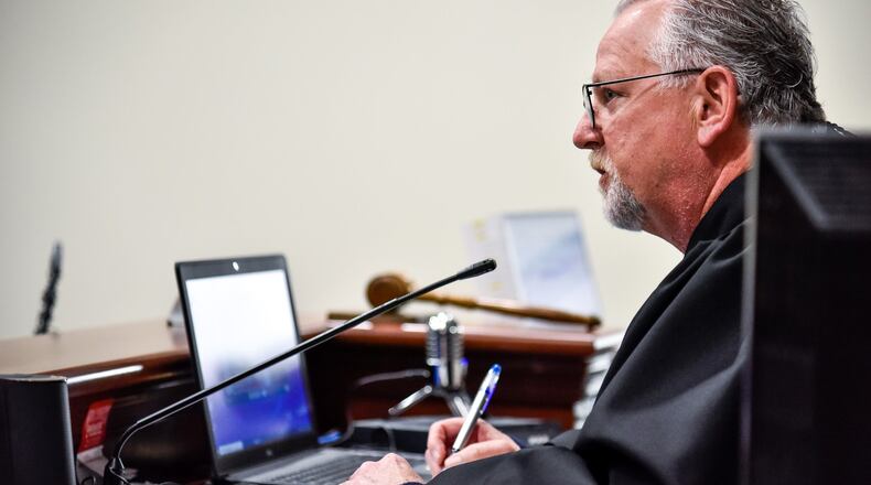 Hamilton Municipal Court Judge Daniel Gattermeyer does his arraignments of people in jail through video using a laptop Friday morning, April 3, 2020 in Hamilton. Hamilton is one of many courts trying to find ways to minimize congestion in the courtrooms to reduce the spread of coronavirus. NICK GRAHAM / STAFF
