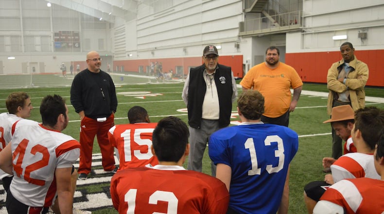 Coach Jay Fry (cap and vest) talks to his club football team after practice in preparation for their final regular-season game, a 39-16 win over Ohio State. CONTRIBUTED/BOB RATTERMAN