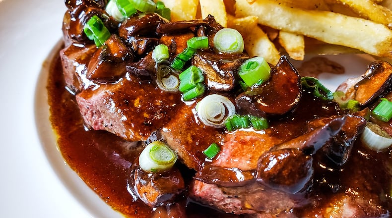 Fretboard Brewing & Public House is now open on Main Street in downtown Hamilton. The brewery and restaurant offers three levels with bar area on the first floor, a dining room area on the second floor and rooftop dining with a view of the Great Miami River. There are multiple beers on tap, craft cocktails and a section of wine. The food options include pub burger and fries, salads, salmon, steak and more. This is their steak frites with sliced New York Strip steak, mushroom bordelaise, green onion and fries.  NICK GRAHAM/STAFF