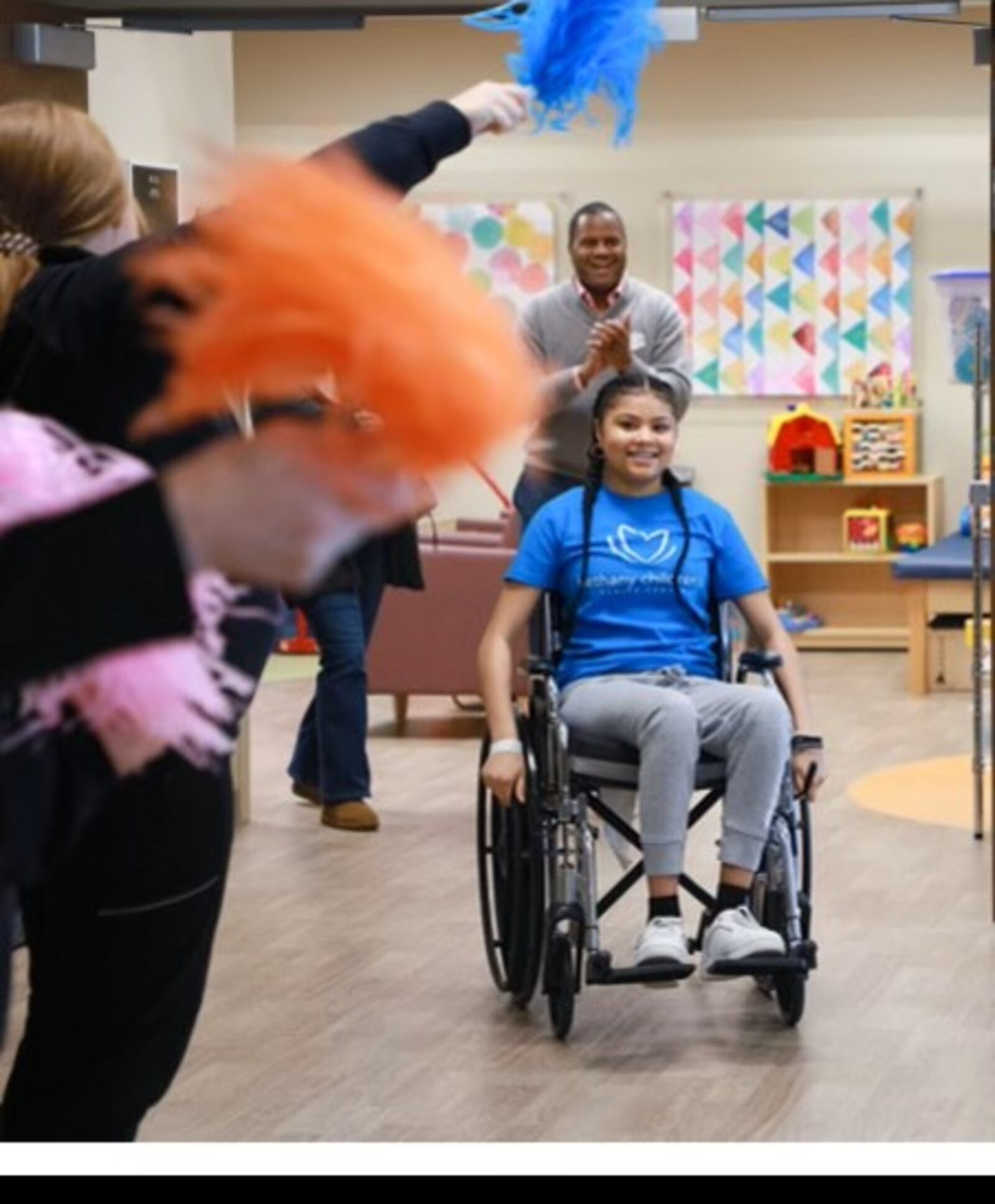 Anaiah Prier is discharged from Bethany Children's Health Center rehabilitation center after being in the hospital for three months. Her father, Darius, of Middletown, applauds in the background. SUBMITTED PHOTO