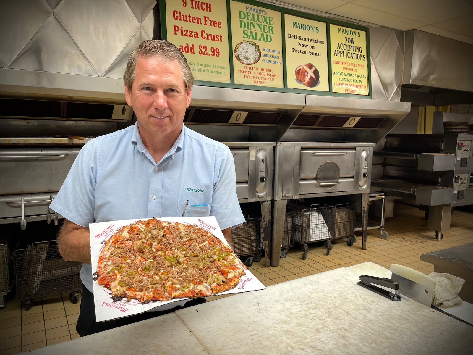 Marion’s Piazza is expecting to sell more than 20,000 pizzas on Wednesday, July 16 during its 60th anniversary sale. Pictured is supervisor John Davis. NATALIE JONES/STAFF