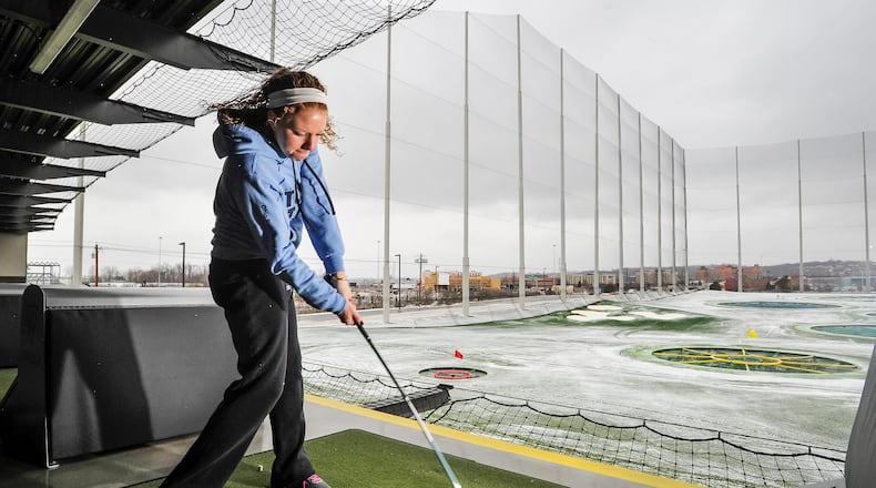 Taylor Jones, from New Carlisle, plays a round at TopGolf as the snow falls Thursday, Jan. 5, in West Chester Twp. TopGolf is an all-season golf entertainment complex with complete bar and restaurant services and heated tees. NICK GRAHAM/STAFF