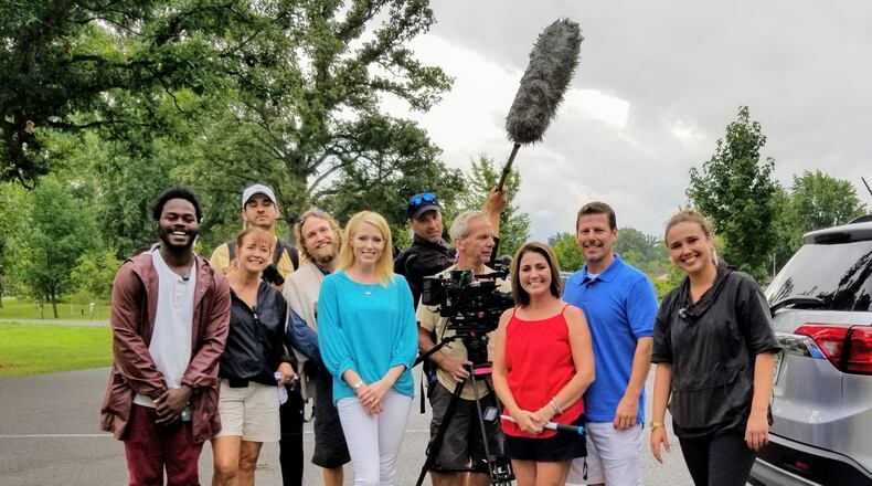 Indian Lake realtor Paige Duff (blue shirt) is pictured with Dayton area residents Chris and Tina Gibbs (second and third from right) and members the crew of HGTV's "Island Life."
