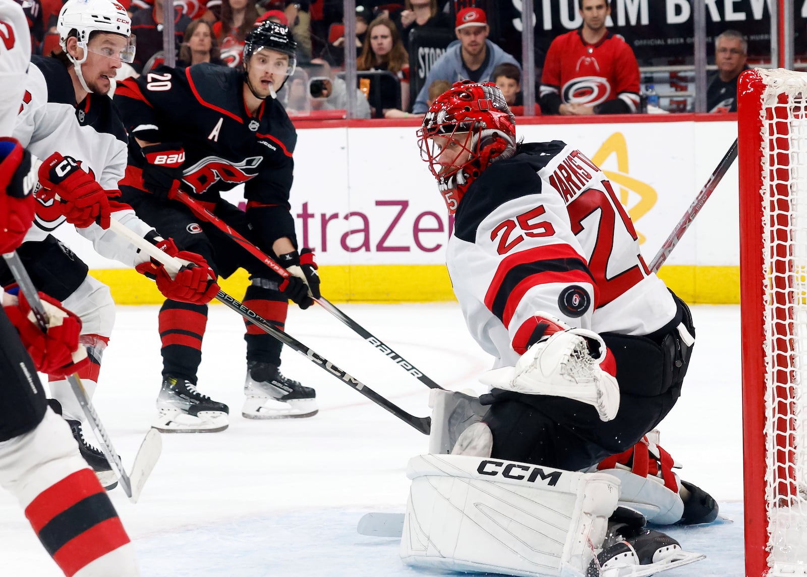 New Jersey Devils goaltender Jacob Markstrom (25) has a shot by Carolina Hurricanes' Sebastian Aho (20) go wide of the net during the second period of Game 5 of an NHL hockey Stanley Cup first-round playoff series in Raleigh, N.C., Tuesday, April 29, 2025. (AP Photo/Karl DeBlaker)