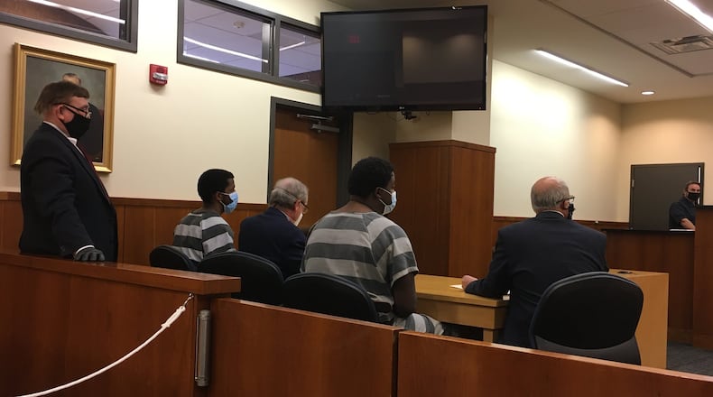 Left to right, Patrick Johnson-Tucker, attorney, Chris Atkins, Nicholas Johnson-Tucker, with attorney Jeffrey Milbauer, in Middletown Municipal Court in May for a hearing. The brothers are charged with robbery and kidnapping for allegedly robbing the CVS on May 2 and tying up the employees. LAUREN PACK/STAFF