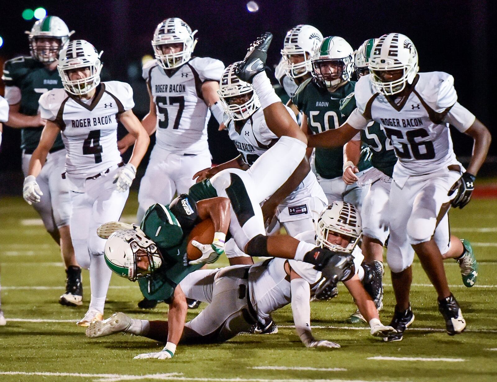Badin’s Davon Starks gets inverted as he carries the ball against Roger Bacon during Friday night’s game at Fairfield Stadium. NICK GRAHAM/STAFF